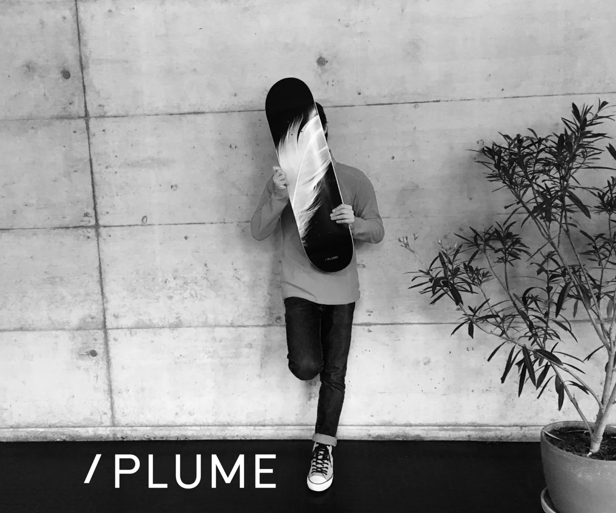 Person holding a Plume skateboard